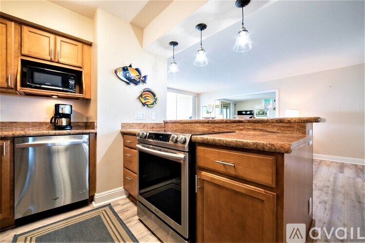 A kitchen with wooden cabinets and granite countertops.