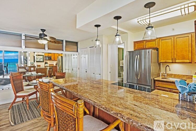 A kitchen with wooden cabinets and a granite countertop.