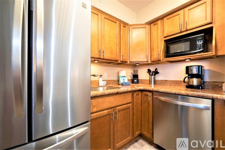 A kitchen with wooden cabinets and stainless steel appliances.