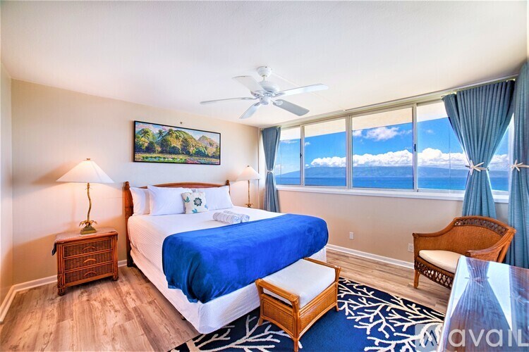 A bedroom with a large bed and a view of the mountains.