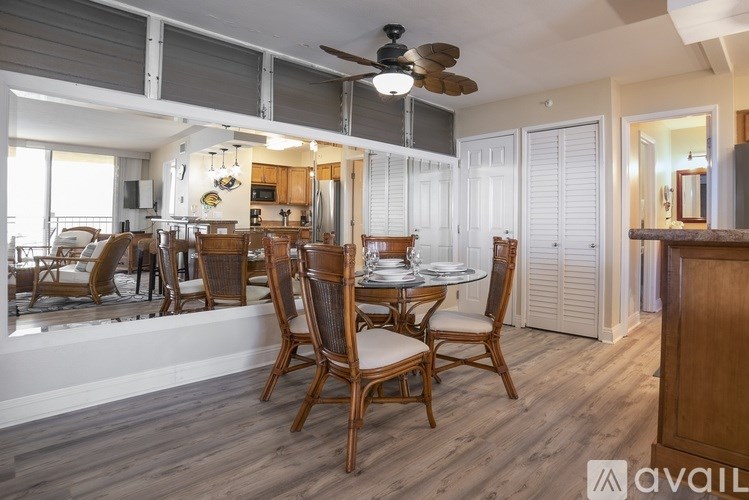 A dining room with a wooden table and chairs.