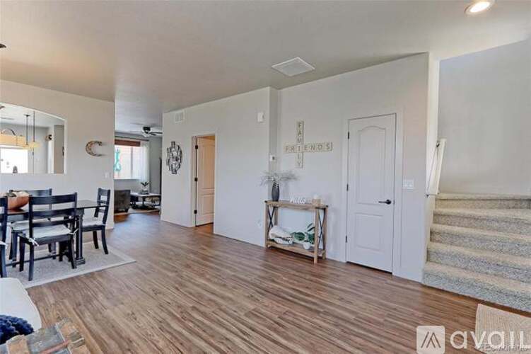 A living room with a dining table and chairs.