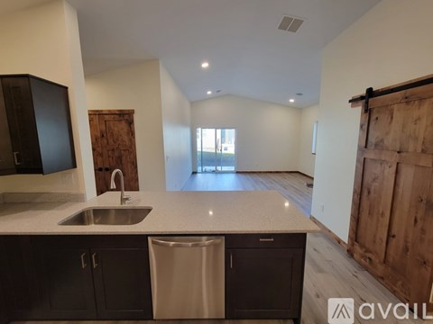A kitchen with a sink and a counter top.