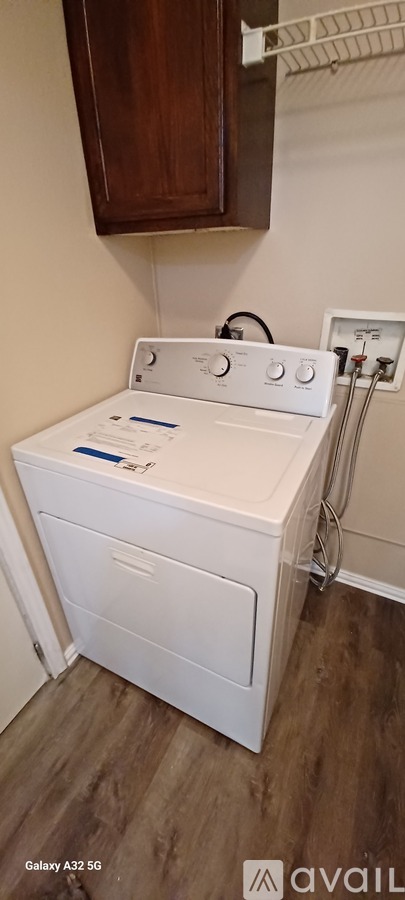 A white washing machine in a laundry room.