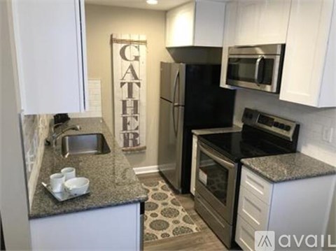 A kitchen with a black fridge and stove.