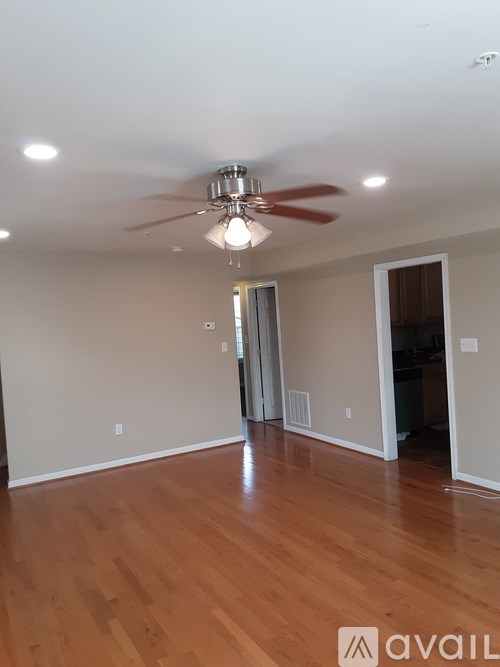 A room with a ceiling fan and light fixture.