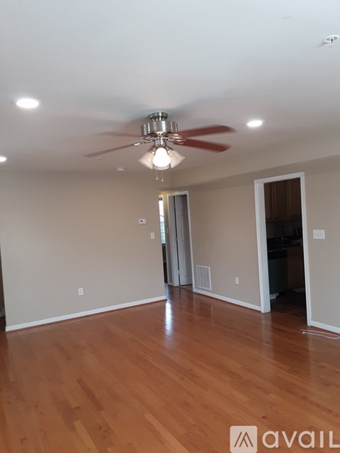 A room with a ceiling fan and light fixture.