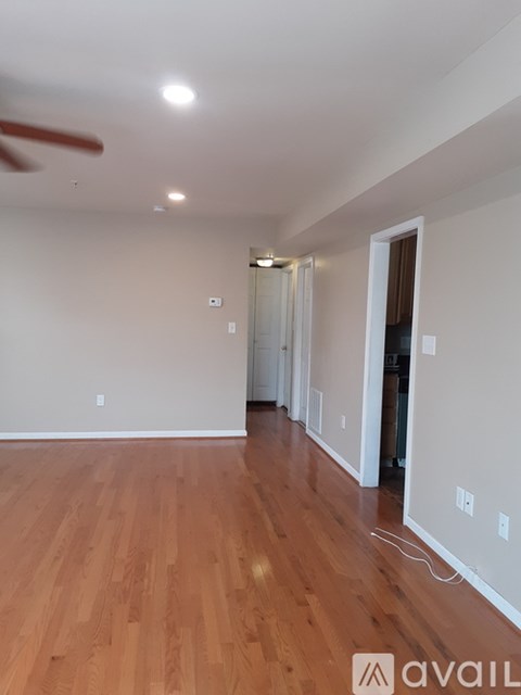 A room with wooden floors and a ceiling fan.