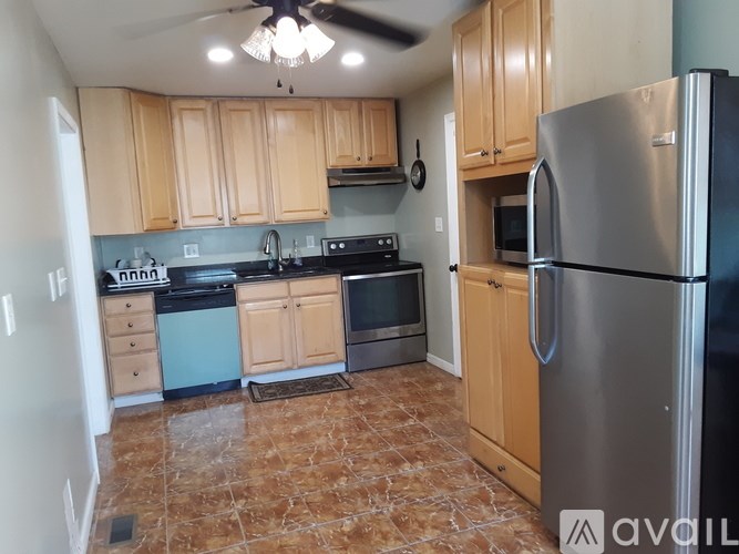 A kitchen with a refrigerator, stove, and oven.