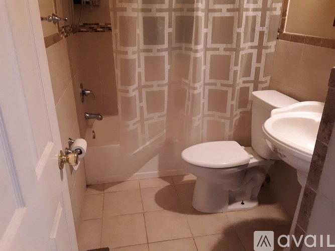 A bathroom with a toilet, sink, and shower.