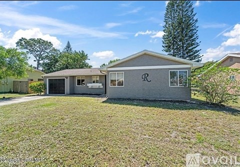 A house with a garage and a driveway in front.
