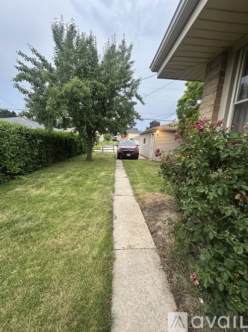 A residential street with a car parked on the side.