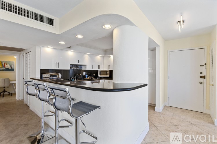 A kitchen with a bar area and a dining table.