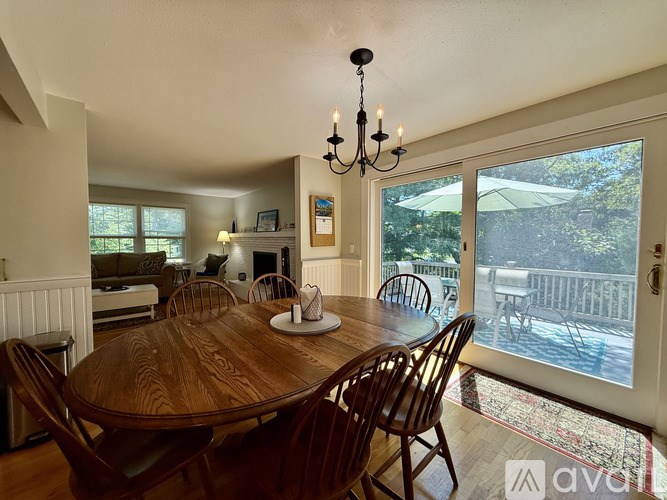 A dining room with a wooden table and chairs.
