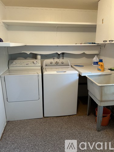 A small laundry room with a washer and dryer.
