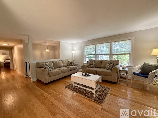 A living room with a couch, chair, and coffee table.