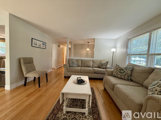 A living room with a white coffee table and two couches.
