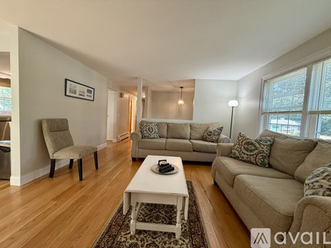 A living room with a white coffee table and two couches.