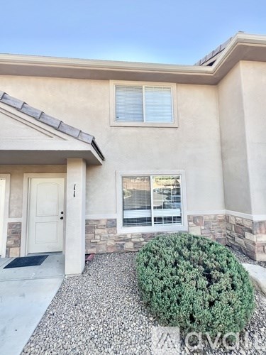 A house with a white door and a window with blinds.
