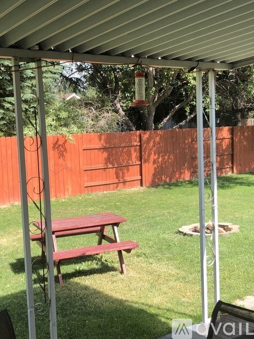 A picnic table is under a white canopy.