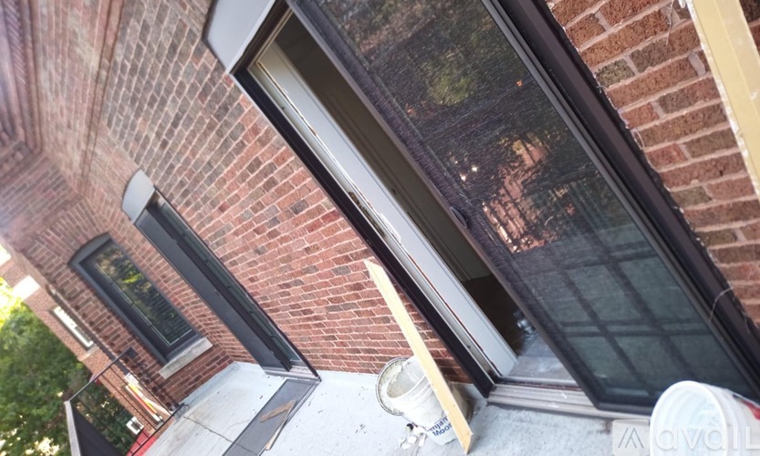 A brick building with a window and a door.