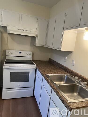 A white oven and sink in a kitchen.