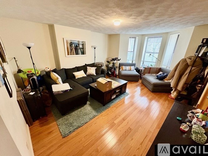 A living room with a couch, chair, and coffee table.