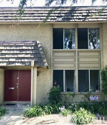 A house with a red door and a brown window.