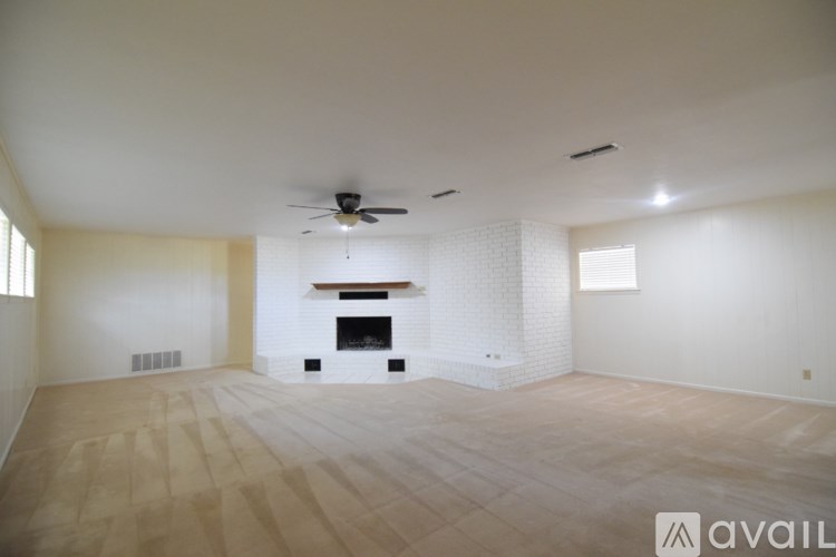 A bathroom with a white tile floor and white cabinets.