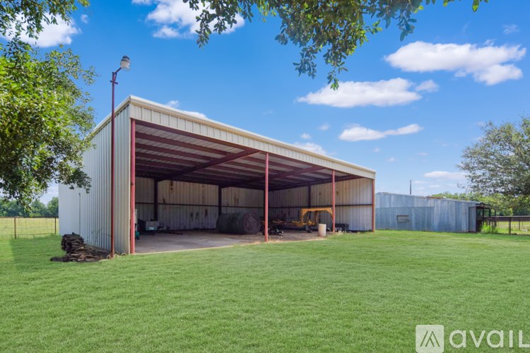 A room with a ceiling fan and a window with blinds.