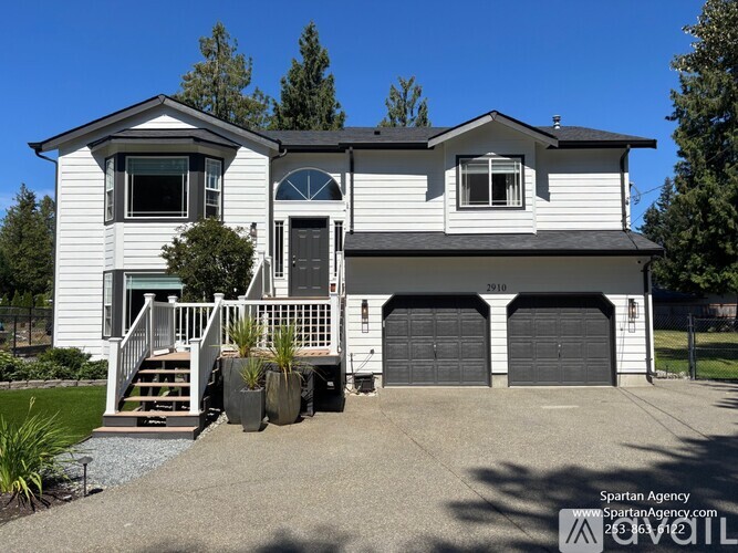A two-story house with a garage and a front porch.