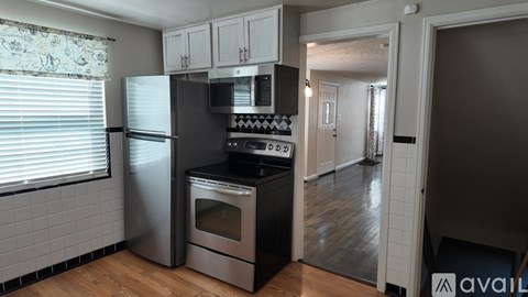 A modern kitchen with a stainless steel refrigerator and oven.
