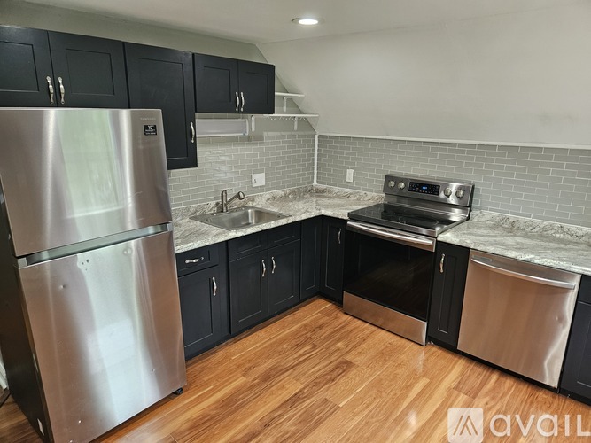 A kitchen with a stainless steel refrigerator, oven, and dishwasher.