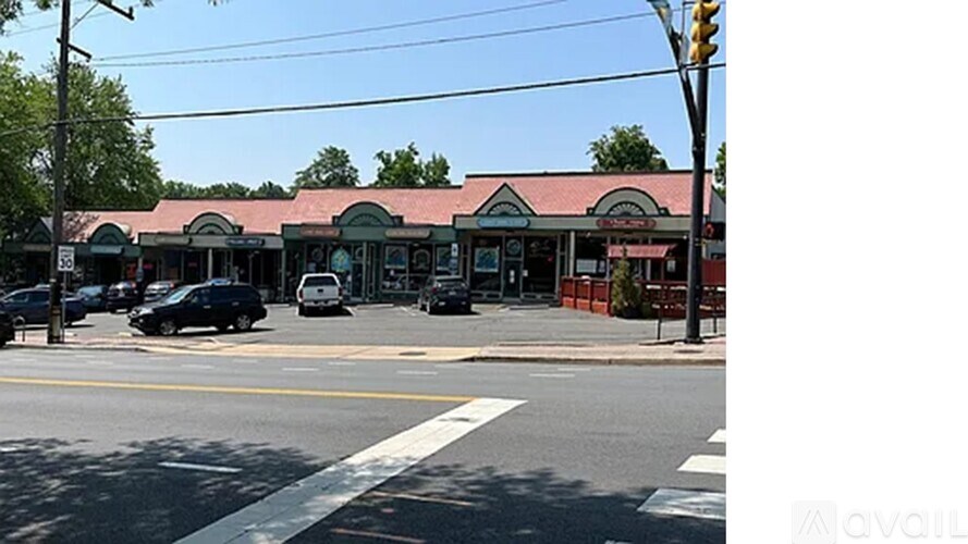 A street view with a car parked on the side of the road.