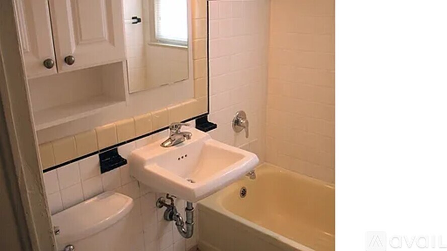 A bathroom with a sink, tub, and toilet.