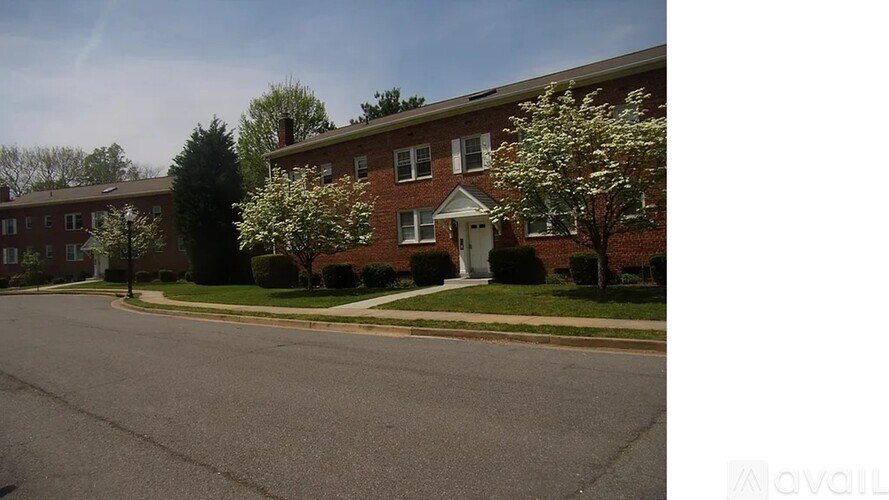 A brick house with a tree in front of it.