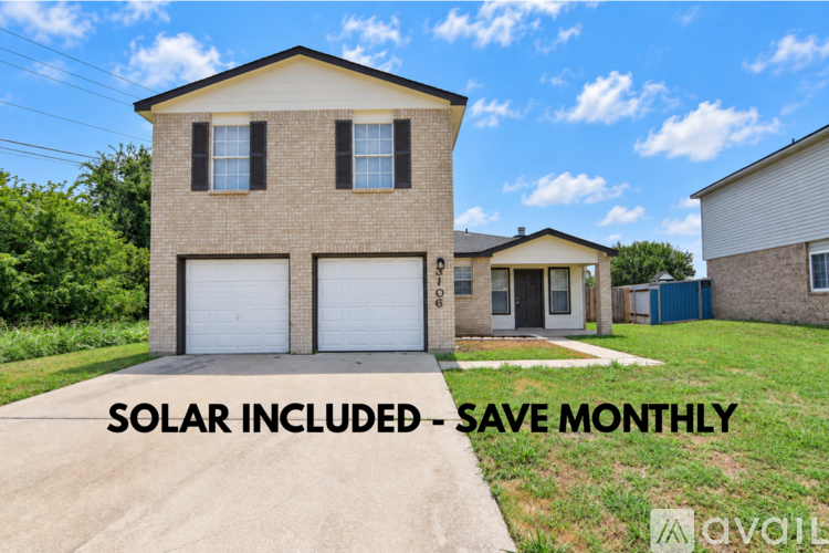 A two-story house with a garage is for sale.
