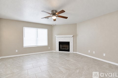 A kitchen with white cabinets and a tiled floor.