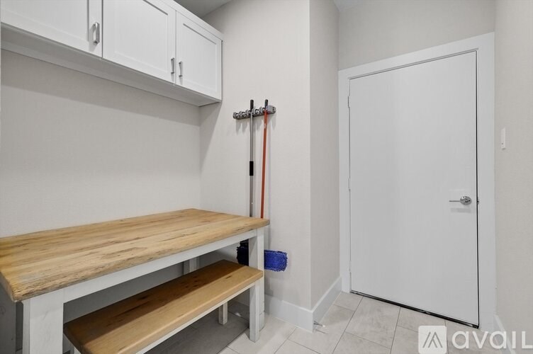 A kitchen area with a white door and a wooden counter.