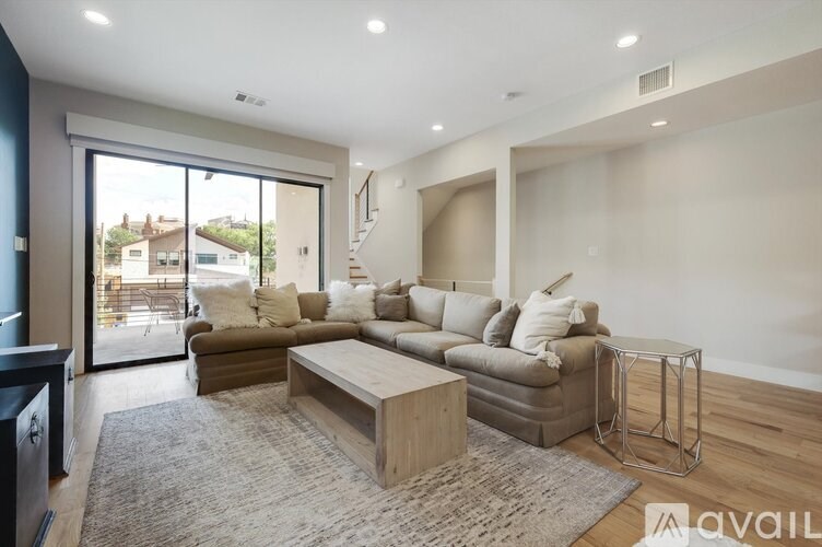 A modern living room with a large sectional sofa and a coffee table.
