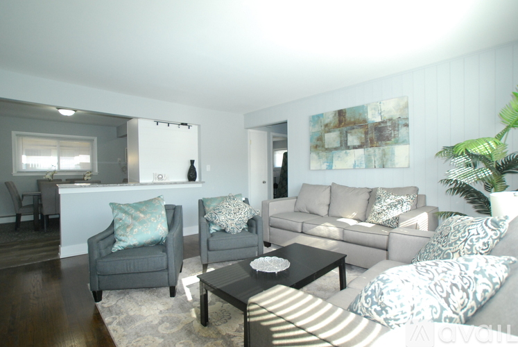 A living room with a grey couch and a coffee table.