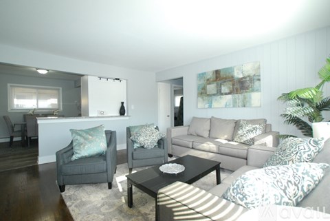 A living room with a grey couch and a coffee table.