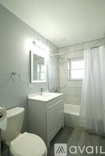 A white toilet sits next to a sink in a bathroom.