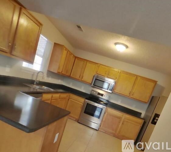 A kitchen with wooden cabinets and stainless steel appliances.