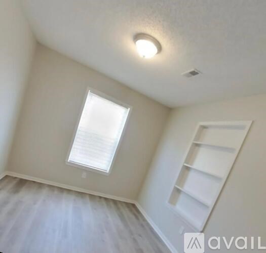 A room with a window and a ladder.