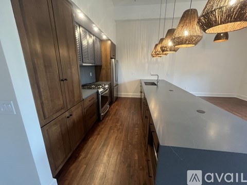 A kitchen with wooden cabinets and a countertop.