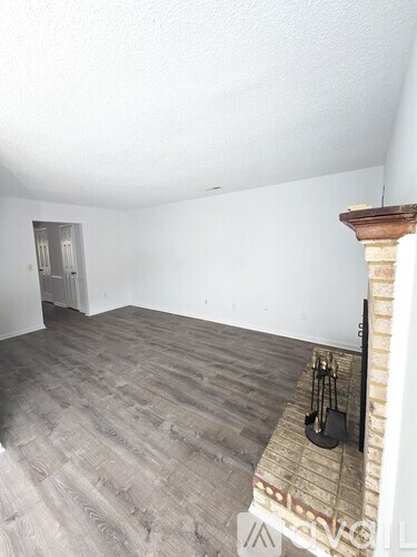 A kitchen with white cabinets and a black dishwasher.
