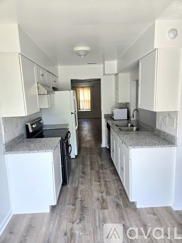 A room with a lot of painting supplies on the floor.