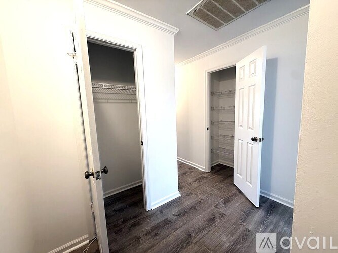 A room with a door on the left and a door on the right.