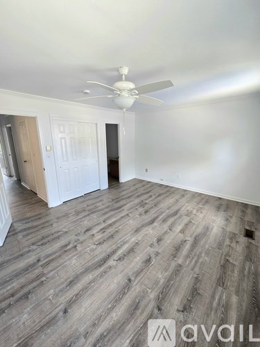 A house with a white door and two windows with blue shutters.